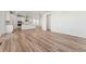 Open concept living room, kitchen, and dining area with hardwood floors at 7267 Prairie Sage Pl, Littleton, CO 80125