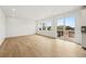 Bright living room featuring hardwood floors and sliding door access to outdoor living at 7267 Prairie Sage Pl, Littleton, CO 80125