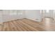 Bright living room with wood-look floors, white walls and large windows at 7267 Prairie Sage Pl, Littleton, CO 80125