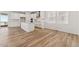 Open-concept living area featuring wood-look floors and an adjacent kitchen at 7267 Prairie Sage Pl, Littleton, CO 80125