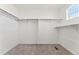 Walk-in closet with carpeted floors and built-in shelving and rods at 7267 Prairie Sage Pl, Littleton, CO 80125