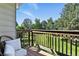 Balcony view overlooking green space with a comfortable chair and a peaceful outdoor setting at 6795 E Arizona Ave # B, Denver, CO 80224