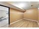 Large basement featuring wood-look flooring and neutral colored walls at 6795 E Arizona Ave # B, Denver, CO 80224
