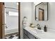 Bright bathroom with a tub and shower combination, and a stylish vanity at 6795 E Arizona Ave # B, Denver, CO 80224