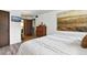 Relaxing bedroom with modern art, wood-look floors, and a minimalist aesthetic creating a serene retreat at 6795 E Arizona Ave # B, Denver, CO 80224