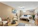 Inviting bedroom with cozy seating, soft lighting, and light wood flooring at 6795 E Arizona Ave # B, Denver, CO 80224