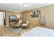 Well-lit bedroom with natural tones, a flatscreen TV, and light wood flooring at 6795 E Arizona Ave # B, Denver, CO 80224