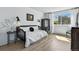 Stylish bedroom with natural light, chic black accents, and light wood flooring at 6795 E Arizona Ave # B, Denver, CO 80224