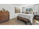 Well-lit bedroom with hardwood floors, a large window, and a comfortable queen bed at 6795 E Arizona Ave # B, Denver, CO 80224