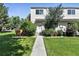 Two-story home with well-manicured lawn and pathway to front door at 6795 E Arizona Ave # B, Denver, CO 80224