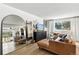 Open-concept living room with leather sectional and large mirror at 6795 E Arizona Ave # B, Denver, CO 80224