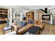 Bright living room features a leather sectional, fireplace and dining area at 6795 E Arizona Ave # B, Denver, CO 80224