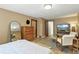 Comfortable bedroom featuring wood-look flooring and a sitting area with natural light at 6795 E Arizona Ave # B, Denver, CO 80224