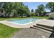 Community pool surrounded by lush trees and green grass at 6795 E Arizona Ave # B, Denver, CO 80224