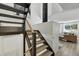 Modern staircase with wood and metal accents leading to a bright living area at 6795 E Arizona Ave # B, Denver, CO 80224