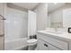 Clean bathroom featuring white tiles, a shower-tub combination and a modern vanity sink at 8883 Ramblestone St, Highlands Ranch, CO 80129