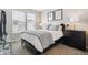 Bedroom featuring modern decor, neutral walls and carpet, and light-filled windows at 8883 Ramblestone St, Highlands Ranch, CO 80129