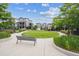 A well-maintained community green space with a bench and lush surroundings at 8883 Ramblestone St, Highlands Ranch, CO 80129