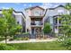 Charming two-story home featuring a fenced yard, balcony and a vibrant blue front door at 8883 Ramblestone St, Highlands Ranch, CO 80129