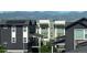 View of neighborhood with modern multi-story homes, varying designs, and mountain backdrop at 8883 Ramblestone St, Highlands Ranch, CO 80129