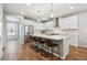 Contemporary kitchen featuring white cabinets, stainless steel appliances, and a large center island with bar stool seating at 8883 Ramblestone St, Highlands Ranch, CO 80129