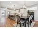 Bright kitchen featuring white cabinets, stainless steel appliances, an island with seating and an adjacent dining area at 8883 Ramblestone St, Highlands Ranch, CO 80129