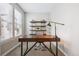 Home office with a large desk, shelving, carpet and natural light from the window at 8883 Ramblestone St, Highlands Ranch, CO 80129