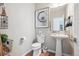 Stylish powder room featuring modern fixtures, decorative accents, and a pedestal sink at 8883 Ramblestone St, Highlands Ranch, CO 80129