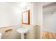 Well-lit bathroom with pedestal sink, medicine cabinet, and classic tile at 3054 S Raleigh St, Denver, CO 80236