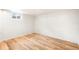 Well lit bedroom with wood floors, white walls, and a single window offering ample light at 3054 S Raleigh St, Denver, CO 80236