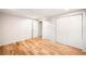 Bedroom featuring natural light wood flooring, neutral walls, closet and entry way at 3054 S Raleigh St, Denver, CO 80236