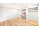 Bright bedroom featuring wooden flooring, a closet, and a built-in shelving unit at 3054 S Raleigh St, Denver, CO 80236