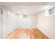 Bright bedroom with hardwood floors, white walls and trim, and window providing natural light at 3054 S Raleigh St, Denver, CO 80236