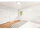 Bright bedroom with a bed featuring patterned throw and view from window at 3054 S Raleigh St, Denver, CO 80236