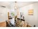 Open concept dining room with a modern table and seamless flow to the kitchen at 3054 S Raleigh St, Denver, CO 80236