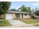 Ranch-style home with a brick exterior, driveway, and a well-kept front yard at 3054 S Raleigh St, Denver, CO 80236