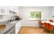 Bright kitchen with white cabinetry, granite countertops, and stainless steel appliances at 3054 S Raleigh St, Denver, CO 80236