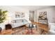 Comfortable living room featuring hardwood floors and neutral tones at 3054 S Raleigh St, Denver, CO 80236