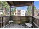 Cozy balcony seating area with views of surrounding trees and the community buildings on a sunny day at 9995 E Harvard Ave # 221, Denver, CO 80231