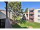 Balcony view of trees and neighboring condo buildings, showcasing the community's green spaces at 9995 E Harvard Ave # 221, Denver, CO 80231