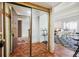 Condo foyer with mirrored closet, hardwood floors, and an open view to the living and dining areas at 9995 E Harvard Ave # 221, Denver, CO 80231