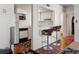 Functional kitchen with white cabinetry, appliances, and open bar area with bar stools at 9995 E Harvard Ave # 221, Denver, CO 80231