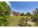 Expansive backyard featuring a lush lawn, mature trees, and a charming patio area at 11462 W Tennessee Pl, Lakewood, CO 80226