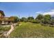 Large backyard with a well-maintained lawn, deck, and plenty of space for outdoor activities at 11462 W Tennessee Pl, Lakewood, CO 80226