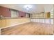 Finished basement featuring built-in shelving, ample space, and vinyl floors at 11462 W Tennessee Pl, Lakewood, CO 80226