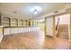 Spacious basement with built-in shelving and vinyl floors at 11462 W Tennessee Pl, Lakewood, CO 80226