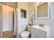 Half bath featuring a white vanity, a toilet, and a neutral color scheme at 11462 W Tennessee Pl, Lakewood, CO 80226