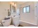 Clean bathroom features a tub-shower combo with white tiles and modern fixtures at 11462 W Tennessee Pl, Lakewood, CO 80226