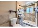 Cozy bathroom with a pedestal sink and walk-in shower with tiled walls at 11462 W Tennessee Pl, Lakewood, CO 80226