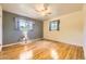 Bright bedroom with hardwood floors, ceiling fan, and windows providing natural light at 11462 W Tennessee Pl, Lakewood, CO 80226